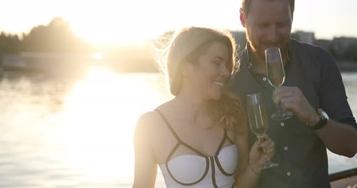 Elegant Couple Celebrating with Champagne at Sunset