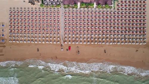 Aerial view of amazing beach with colorful umbrellas and turquoise sea