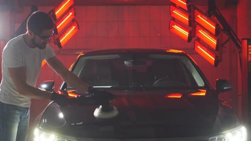 Master Polishes the Car in a Car Workshop.