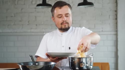 Chef Prepares Noodles in Restaurant Kitchen