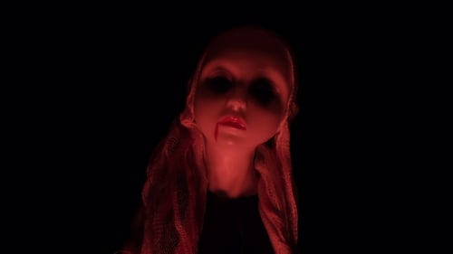 Doll with a White Veil in Red Lighting