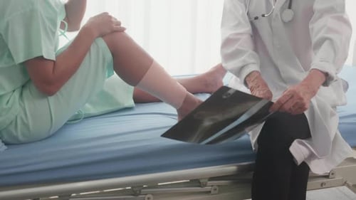 Doctor Explains X-Ray to Patient in Hospital