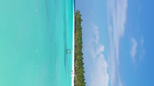 Tropical Island with Coconut Palm Trees and Turquoise Caribbean Sea with Floating Boats