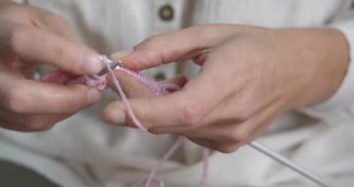 Woman Hands Knitting Pink Yarn Close Up