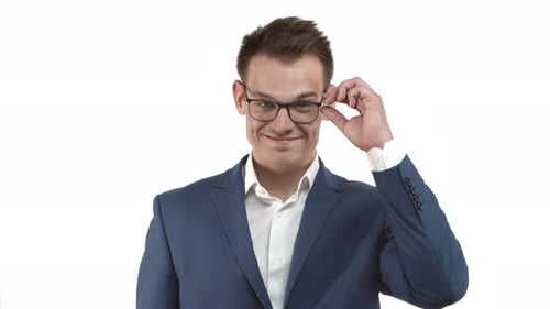 Handsome Smiling Businessman in Blue Suit Looking Over Glasses with Pleased Expression Standing