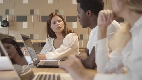 Collaborative Team Discussing Ideas in Modern Office