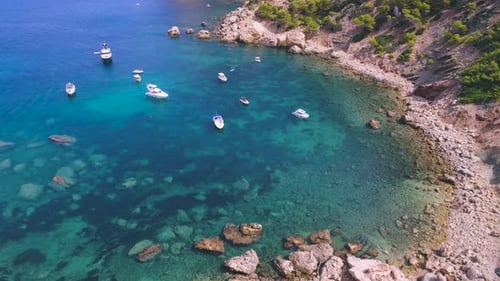 Wild rocky beach with boats