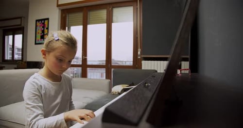 Young Girl Plays Piano at Home
