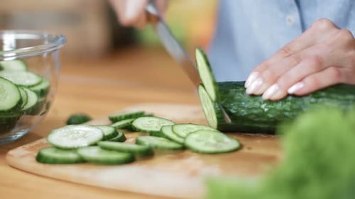 Close Up Female Hands Cutting Cucumber on Wooden Board Use Knife
