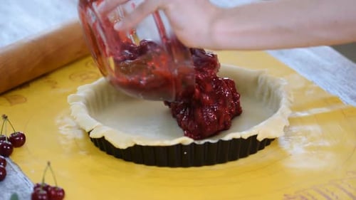 Filling a Cherry Pie Crust with Cherry Filling