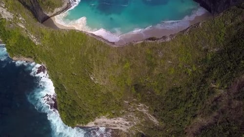 Dramatic aerial view flight high bird's eye view drone shot ofer edge cliff big waves
Kelingking Be