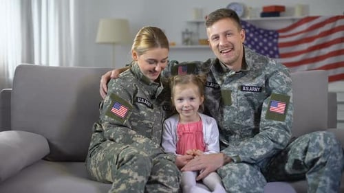 Happy Military Family Poses Together on Sofa