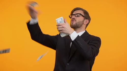 Young Man Tossing Money, Celebrating Success