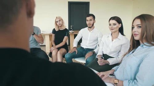 Group Sitting in Circle at Corporate Meeting