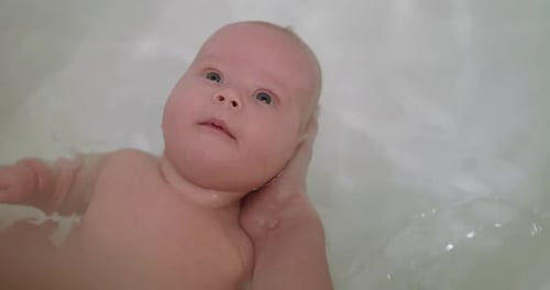 Infant Having a Bath in Tub