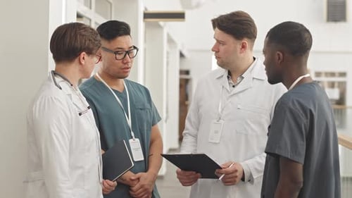 Medical Team Talking in Hospital Corridor