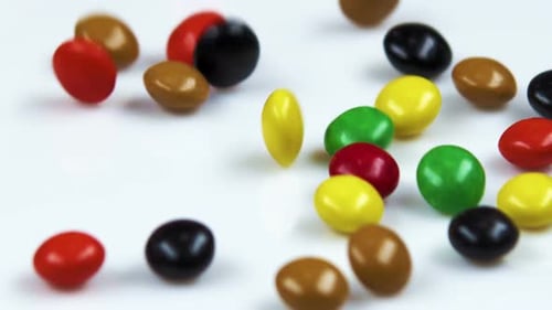 Colorful Candies Falling onto a White Surface
