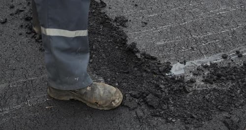 Laying Asphalt In A Pothole. Road Repairs