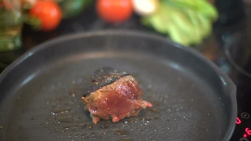 Juicy Piece of Meat Sizzling in a Pan