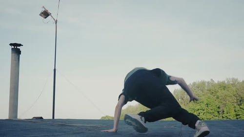 Man Does Headstand on Rooftop During the Day