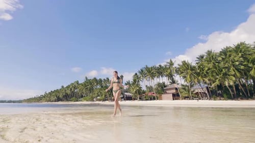 Happy Young Woman in Bikini Running on Wet Sand at Sea Beach. Attractive Girl Enjoying Sunny Day