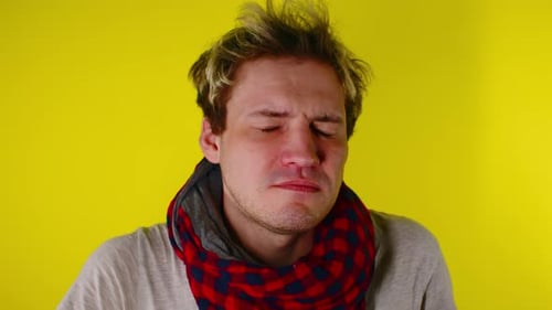 Sick Young Adult Blowing Nose with Tissue