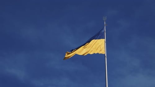 Ukrainian Flag Waving Proudly Against Blue Sky