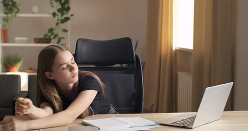 Young Woman Sits at Office Feels Tired From Paper Work Closes Turns Off Laptop Puts Head on Table