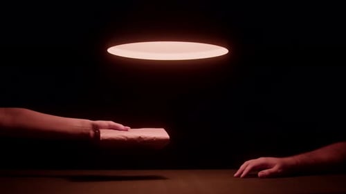 Hand Rejects Brown Paper Package in Dark Room