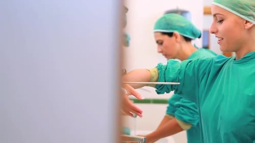 Medical Staff Washing Hands in Hospital Sink