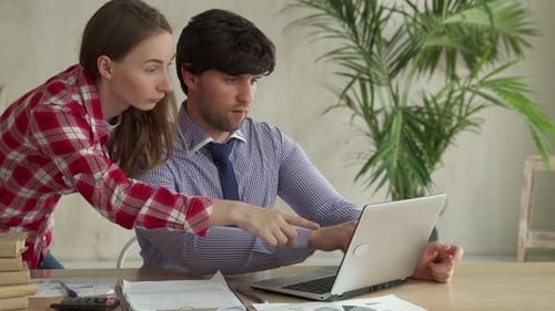 Young Couple Working Together at Office