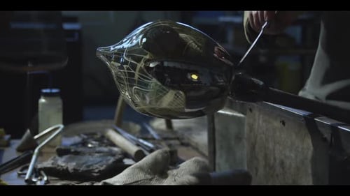 Glassblower Shaping Molten Glass into Art