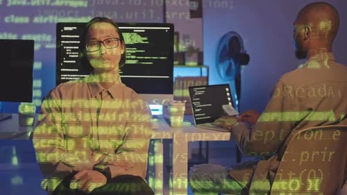 Portrait of Tired Asian Programmer at Dark Office