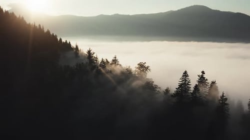 Aerial View of Misty Mountains at Sunrise