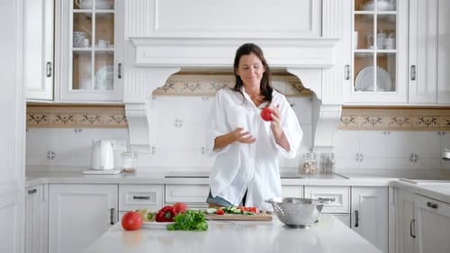 Woman Happily Dancing in Bright Modern Kitchen