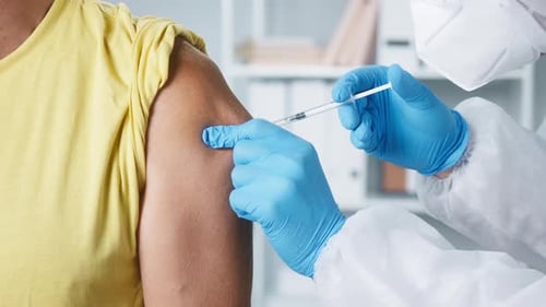 Healthcare Worker Administers Vaccine in Doctor's Office