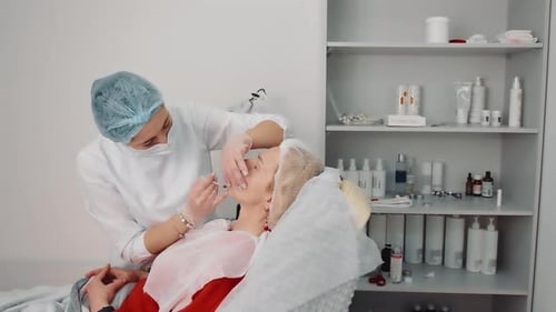 Aesthetician Giving Cosmetic Injection to Patient