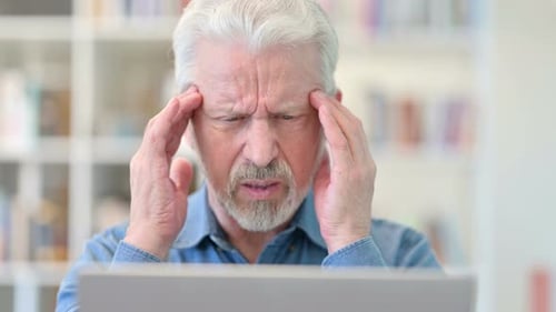 Close Up of Old Businessman Having Headache at Work