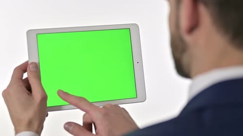 Man Using Tablet With Green Screen Display