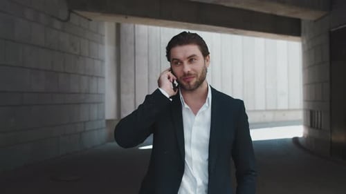 Businessman Talking on Cellphone in City. Male Professional Celebrating Success