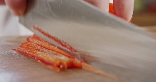 Slicing a Fresh Red Bell Pepper on Board