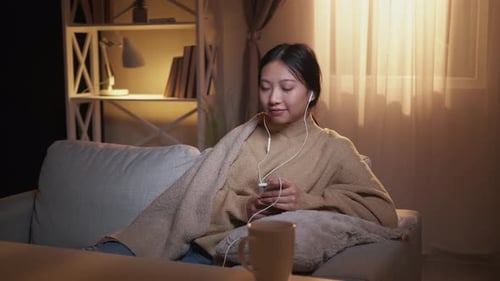 Woman Relaxing at Home with Mobile Phone