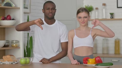 Young Couple Presenting Vegetables Dislike with Thumbs Down