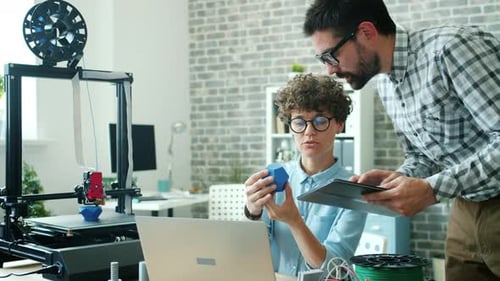 Engineers Girl and Guy Discussing 3D Printed Model in Office Using Tablet