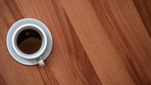 Coffee Being Poured into a Cup on a Table