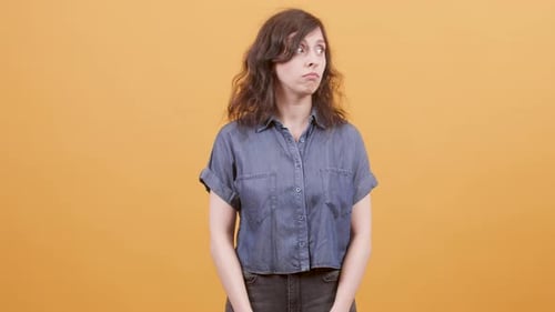 Woman Gesturing and Posing on Orange Background