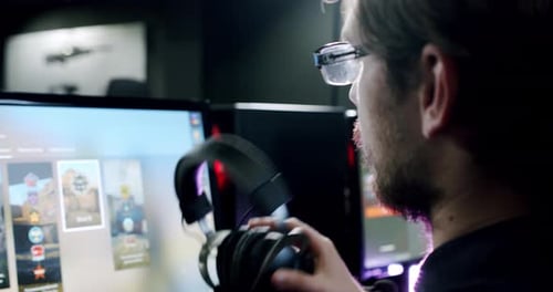 Gamer Plays an Online Video Game, and Comments Into the Microphone , Close Up