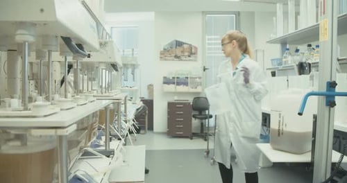 Scientist Pouring Liquid in Bright Medical Laboratory