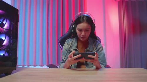 Girl Gamer Playing Video Game On Mobile Phone