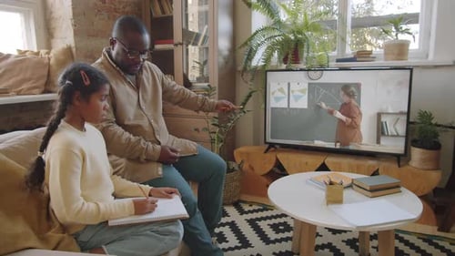 Man and Child Watching Math Lesson Together